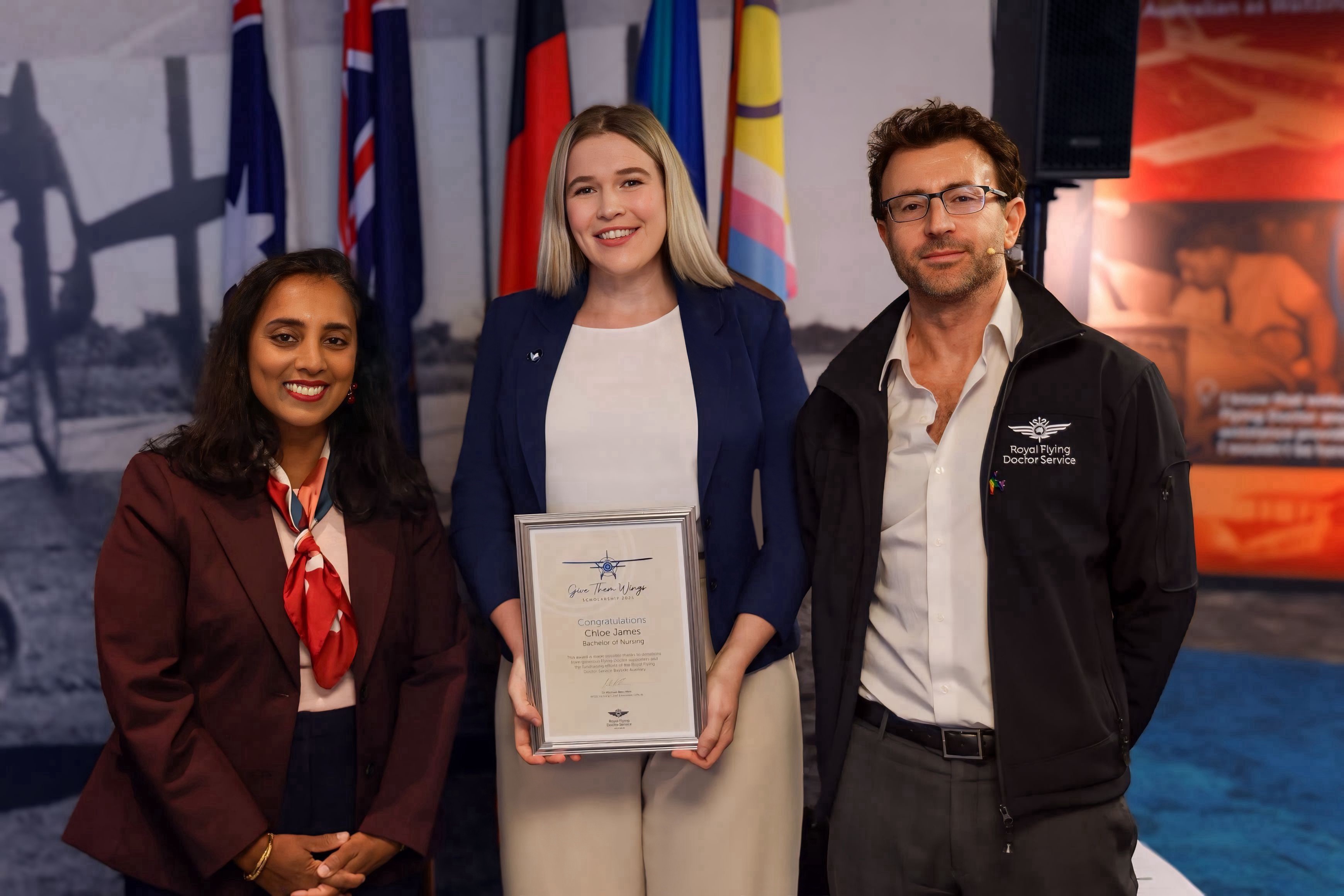 Dr Senator Michelle Ananda-Rajah MP and RFDS Victoria CEO Dr Michael Ben-Meir present the award to Chloe (pictured middle).